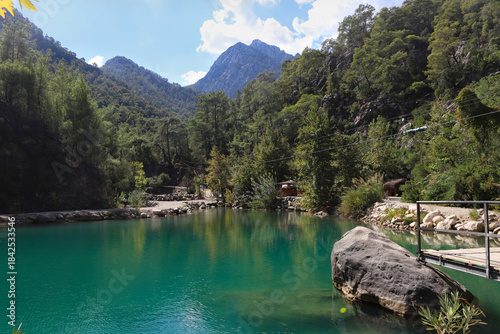 Small pond in the mountains with turquoise water in Goynuk canyon,  Turkey. Emerald lake in the forest surround mountains.
