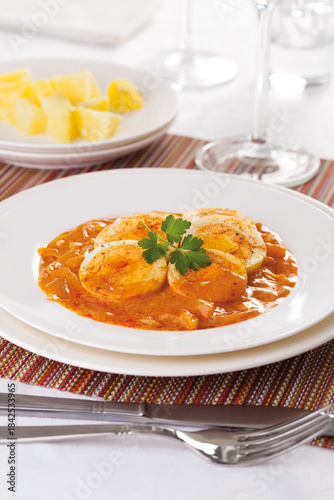 Vegetable stew with boiled egg, served with boiled potatoes.