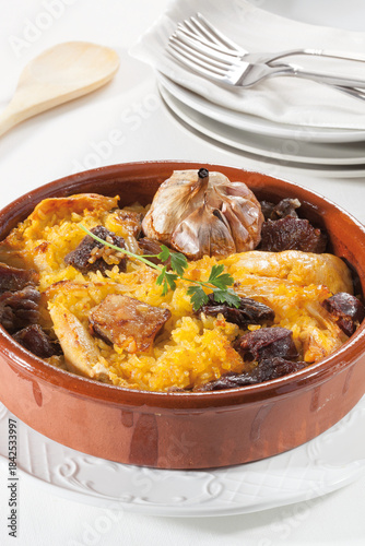 Traditional baked rice with cured meats, sausages, and meat