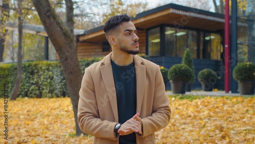 Worried Hispanic man guy in autumn park look around waiting for meeting looking searching disappointed nervous wait sad male standing outdoors in fall season city lateness problem cancel appointment