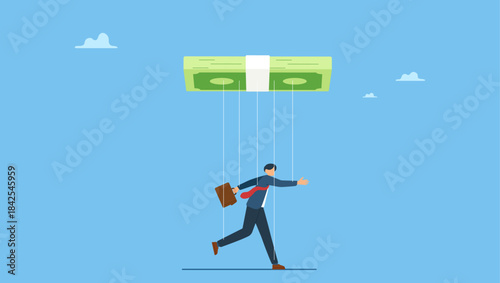 Businessman puppet doll being controlled by money. Being controlled by money, capitalism, greedy working environment, slavery, decision manipulation or bribery and corruption.