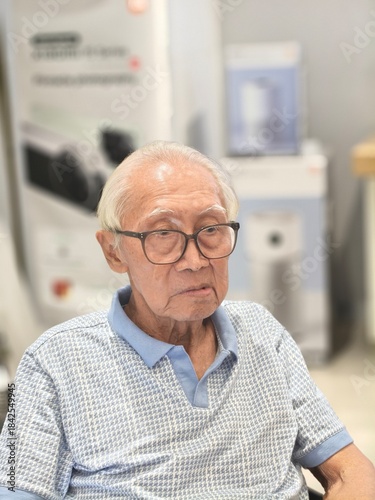 Close-Up Portrait of a Distinguished Elderly Asian Man with Eyeglasses