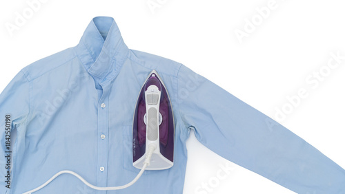 Top view of a purple electric iron placed on a light blue shirt while ironing