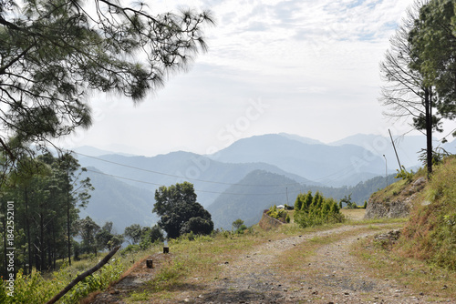 Beautiful green mountain with blue and white clouds in the sky.