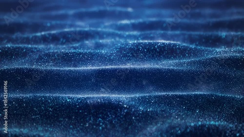 Abstract dark blue waves made of tiny shimmering particles, bokeh effect