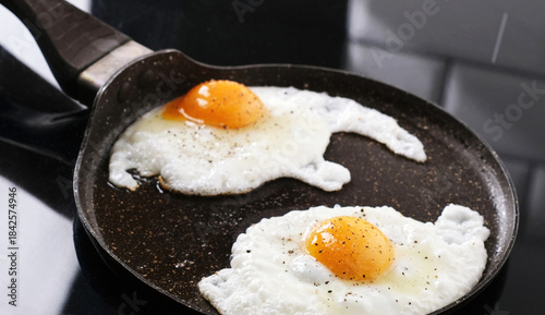 Obraz na płótnie Fried Eggs In A Frying Pan In Close Up View