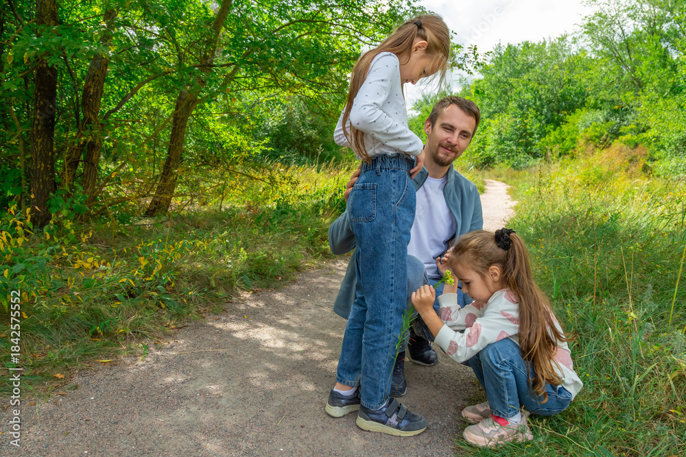 Fototapeta premium Father and children have fun, laugh and enjoy nature outdoors.