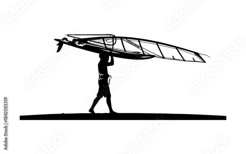 Silhouette of a man carrying a windsurfing board and sail on his head.