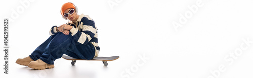 Stylish teenager showcases fashion and confidence on a skateboard background