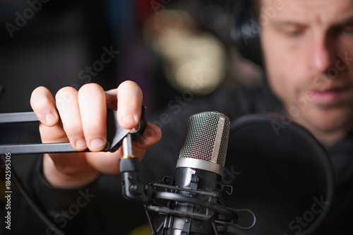 podcaster with microphone copy space background image, selective focus image, horizontal, white male, model, handsome guy
