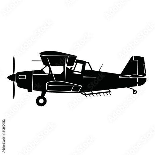 Silhouette of a classic biplane crop duster aircraft in flight.