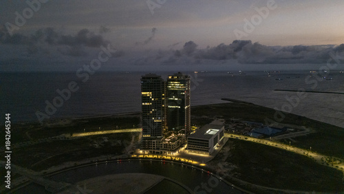 Aerial view of the Eko Atlantic City's skyline glows against the dark horizon, a modern marvel on the edge of the Atlantic, Lagos, Lagos, Nigeria.