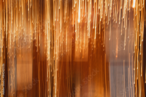 Bild auf Leinwand Dynamic Motion Blur of Glimmering Golden Light Strands Cascading Downward, Creat