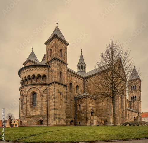 Viborg Cathedral with towers and round apse against a grey sky