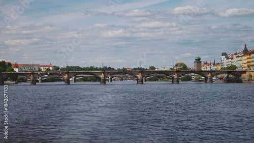 Famous Prague stone bridge with buildings.