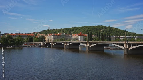 Famous Prague stone bridge with buildings.