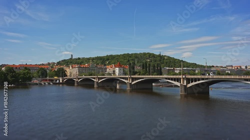 Famous Prague stone bridge with buildings.
