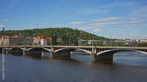Famous Prague stone bridge with buildings.