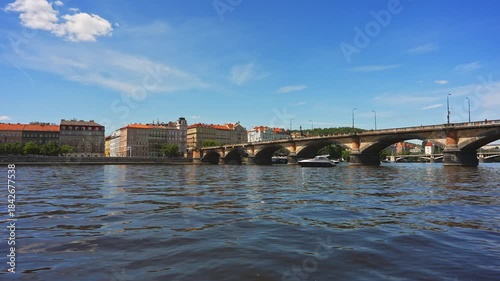 Famous Prague stone bridge with buildings.