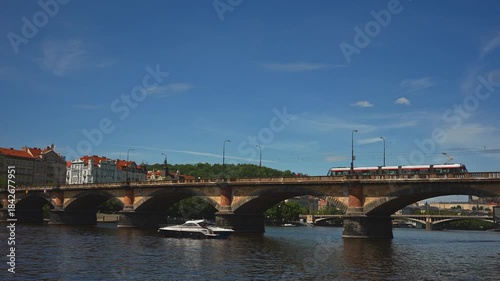 Famous Prague stone bridge with buildings.