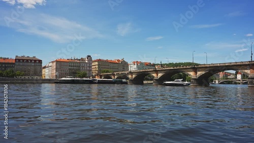 Famous Prague stone bridge with buildings.