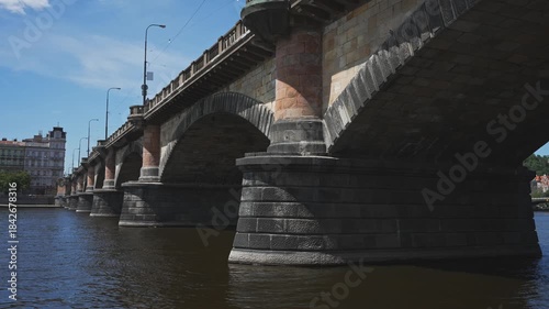Famous Prague stone bridge with buildings.
