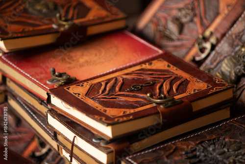 Handcrafted leather journals displayed in an artistic arrangement showcasing intricate designs and textures