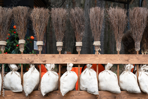Row  of brooms as decorative elements . cleaning concept