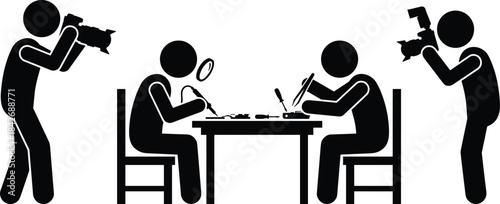 Silhouette photographers capturing two people repairing electronics with tools and magnifying glass at table in workshop setting