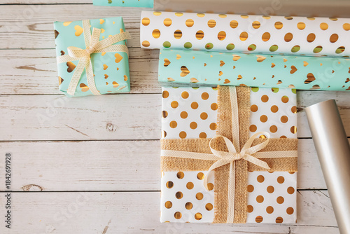 Wallpaper Mural Assorted gift boxes and decorative wrapping paper rolls on rustic wood background. Trendy and cozy flat lay for holiday packaging, DIY gift wrap and creative branding Torontodigital.ca