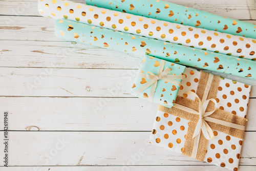 Wallpaper Mural Stylish gift wrapping scene with paper rolls and decorated boxes on modern textured background. Flat lay for DIY projects, festive promotions, and seasonal branding Torontodigital.ca