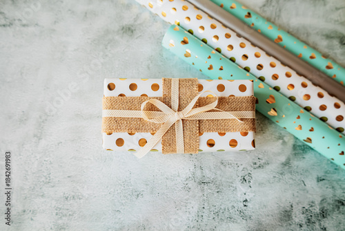 Wallpaper Mural Stylish gift wrapping scene with paper rolls and decorated boxes on modern textured background. Flat lay for DIY projects, festive promotions, and seasonal branding Torontodigital.ca