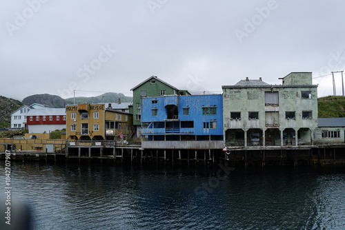 Main street of the fisherman Nyksund town with old colorful warehouse buildings during summer saison in Norway