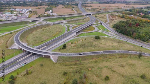 Traffic flows through a complex highway interchange in daylight hours
