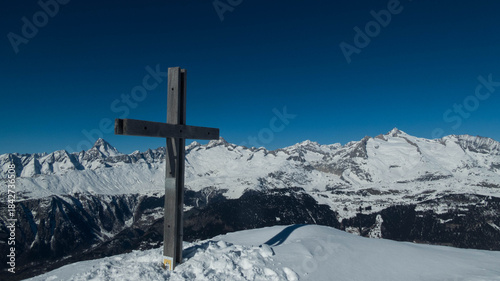 woodden cross on folluhorn summit during winter , switzerland