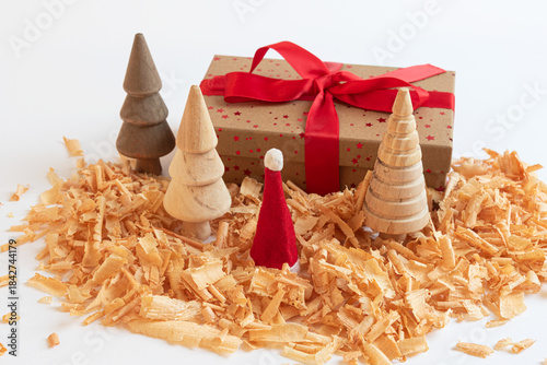 Christmas gift box with wooden trees and Santa hat on white