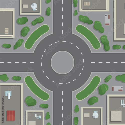 A city street with a round intersection and a green median