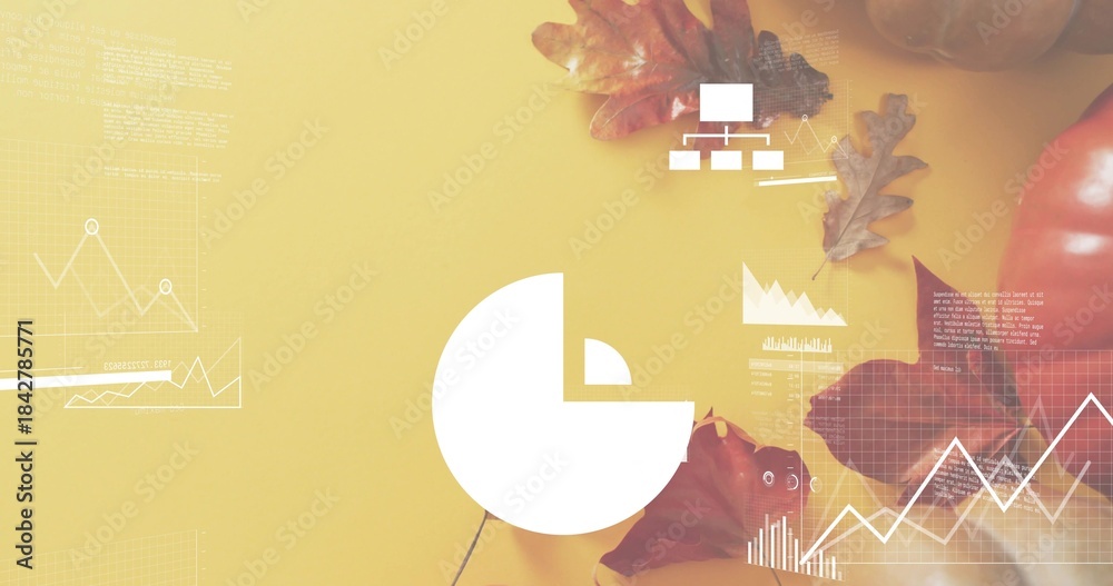 Fototapeta premium Displaying white pie-chart centered on mustard tabletop, showing line graphs, oak leaves, pumpkin