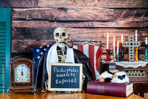 фотографія skeleton smoking pipe holding sign pedophiles need to be exposed