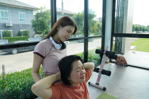 Wallpaper Mural Personal trainer guiding woman during workout session in gym Torontodigital.ca