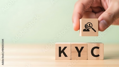 Know your customer concept with a hand holding a wooden block with a person s icon above kyc blocks
