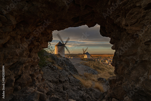 Windmills at sunset within a natural setting in Consuegra, Toledo, Spain.
