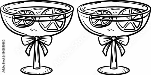 Two decorative cocktail glasses with citrus slices and ribbon adornments