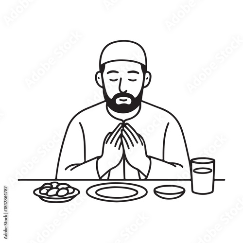 Muslim man offering prayer before breaking fast with traditional meal