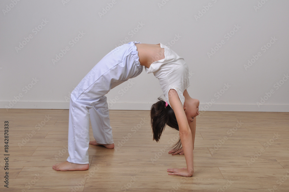 Obraz premium menina faz treino de capoeira e flexibilidade 