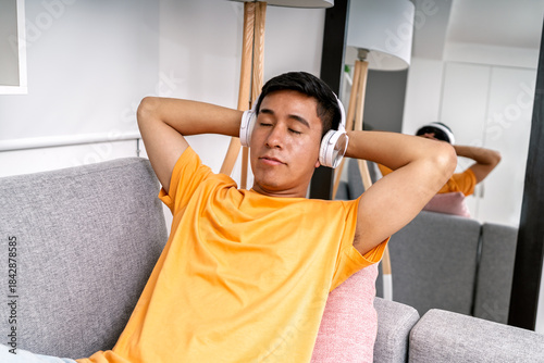 Photography Young man relaxing listening to music at home