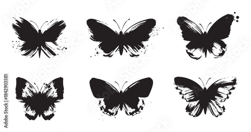 Six grunge brush stroke butterflies with artistic ink splatters form a decorative and elegant insect collection, ideal for various design projects.