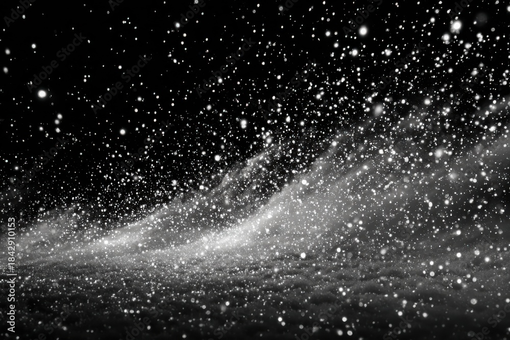 Obraz premium Snow falling gently on dark clouds during winter night creating a snowy scene above the landscape