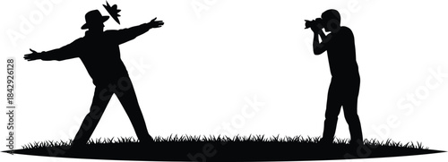 Silhouette of a photographer capturing a performer in a dynamic pose