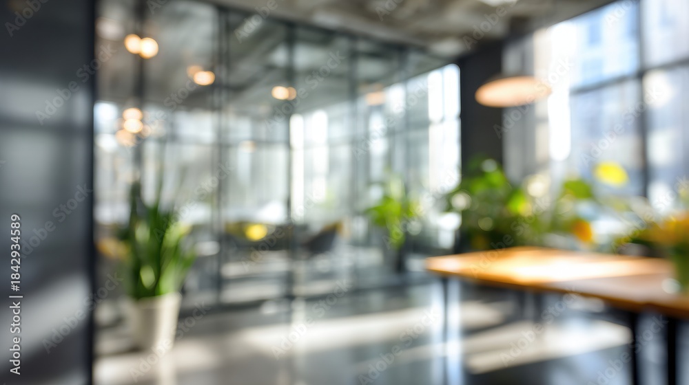 Fototapeta premium Blurred modern office interior with glass partitions and plants